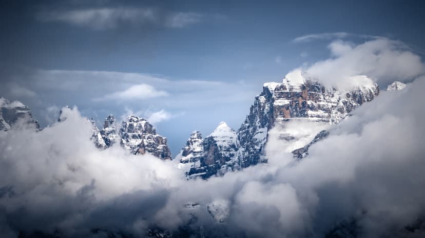 Snowy Italian mountain landscape with clouds rolling in