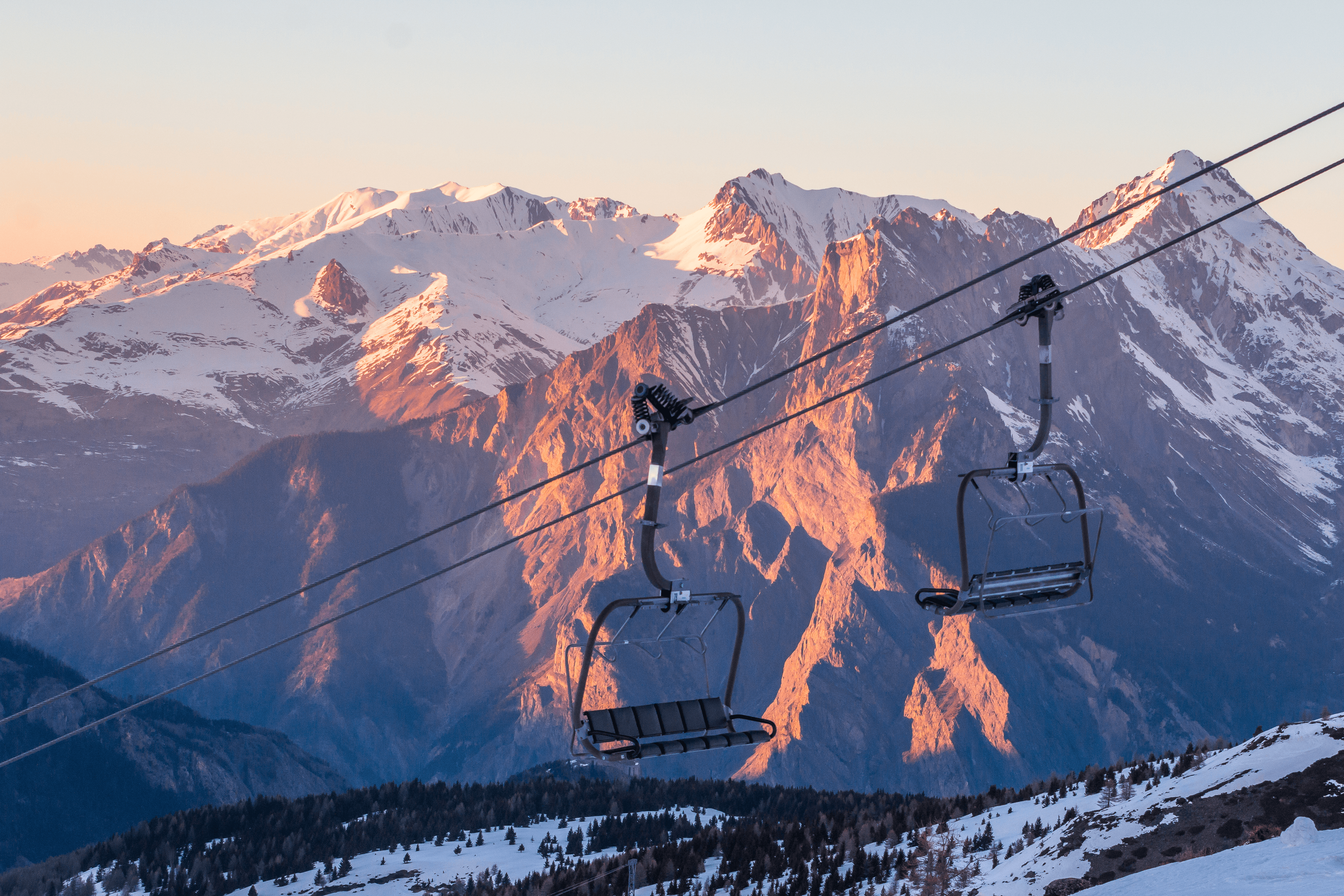 Empty chairlifts at sunset in ski resort